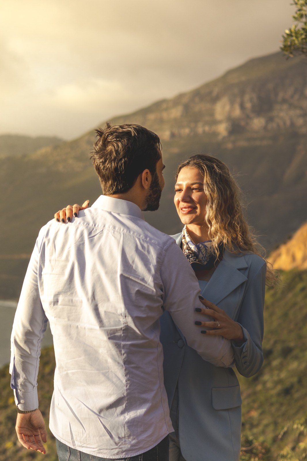 Woman smiling at her partner with mountains in the background